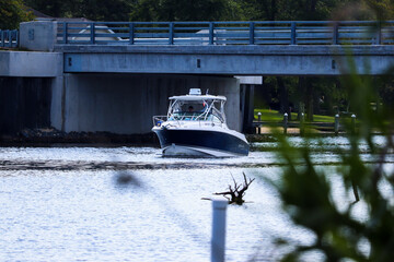 Boat on the river passing under bridge 