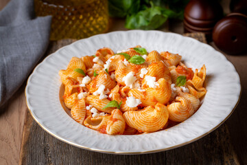 Tomato ravioli pasta or pipe rigate shaped pasta on the cheese