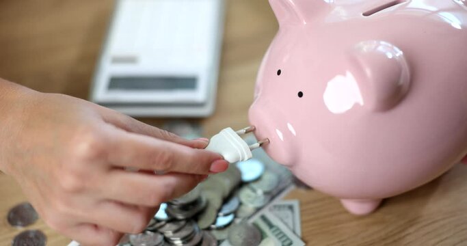 Fork in hand and piggy bank with coins and calculator