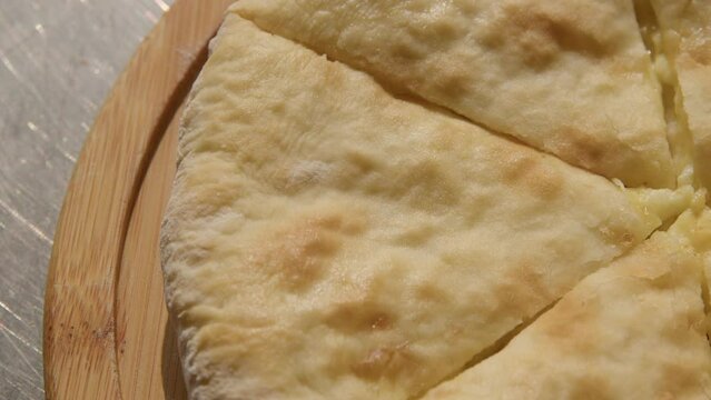 Fresh Baked Cheese-filled Georgian Flatbread Khachapuri Imeruli (Imeretian), closeup