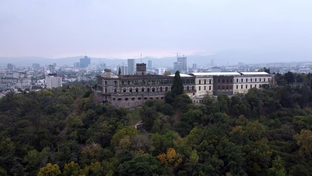 Flying in a beautiful sunset with the shot of Chapultepec Castle