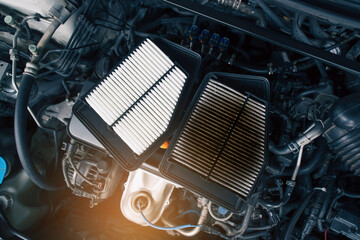Comparison of new and old car air filters that are clogged up on the engine compartment, Automotive...