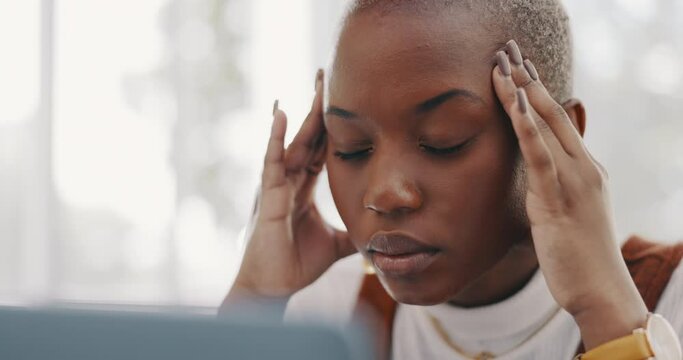 Stress, burnout and headache of black woman on laptop typing email in office at marketing company. Anxiety, tired and migraine of employee frustrated thinking of professional online response.