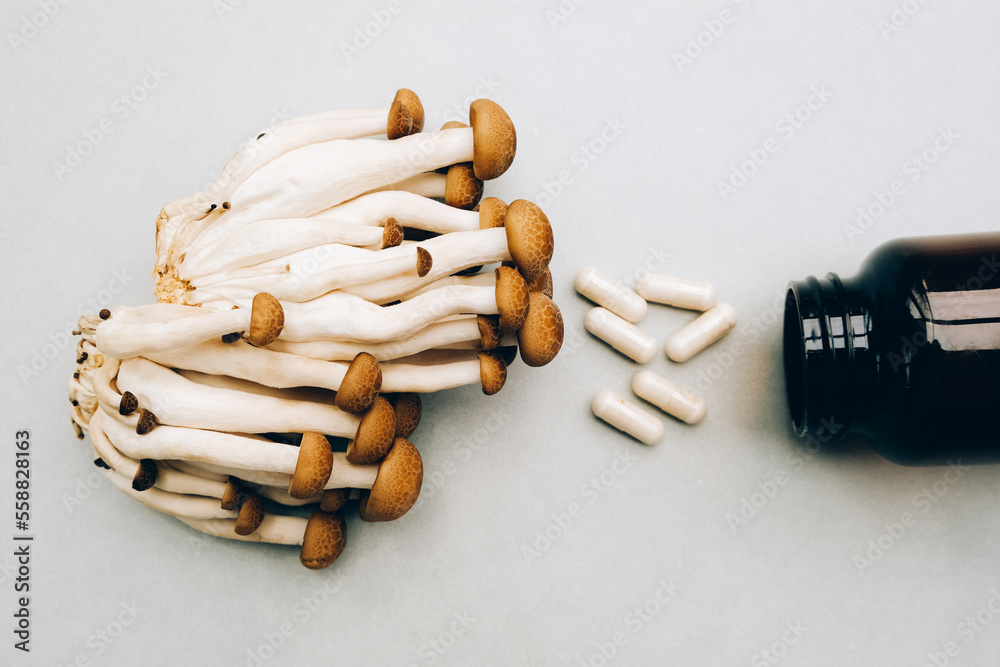 Wall mural medicinal shiitaki mushrooms, pills and jar on white background