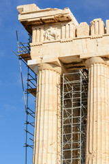 View of the reconstruction of the Doric columns of the Acropolis against the blue sky in Athens
