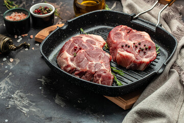 Fresh raw beef steaks with rosemary and pepper on grill pan. Culinary, cooking concept. Long banner format