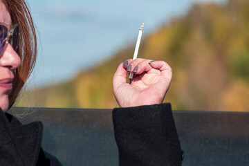 woman holding cigarette