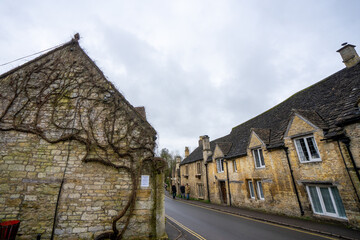 Fototapeta na wymiar Castle Combe , Beautiful village in Cotwolds with old stone houses bridge and river during winter in Wiltshire , United Kingdom : 6 March 2018