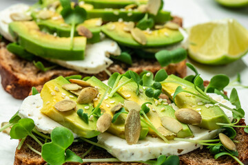 avocado toasts with cheese, pumpkin, nut and sesame. Healthy fats, clean eating for weight loss