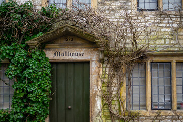 Fototapeta na wymiar Castle Combe , Beautiful village in Cotwolds with old stone houses door window during winter in Wiltshire , United Kingdom : 6 March 2018