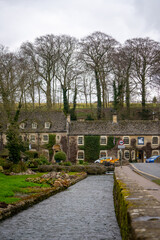 Classic Swan hotel in Bibury , classic villages in Cotwolds stone buildings and river coln during winter cloudy day at Gloucestershire , United Kingdom : 6 March 2018