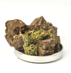 Dried marijuana, glass jar lid on white background. Medical marijuana dispensary Alternative medicine Cannabis plantation for medical and business concept.