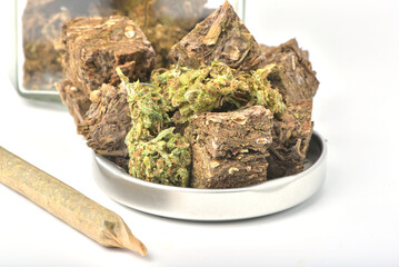 Dried marijuana, glass jar lid on white background. Medical marijuana dispensary Alternative medicine Cannabis plantation for medical and business concept.