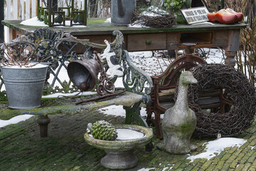 A small warehouse of old garden decorations in the courtyard of the house. - 558835524