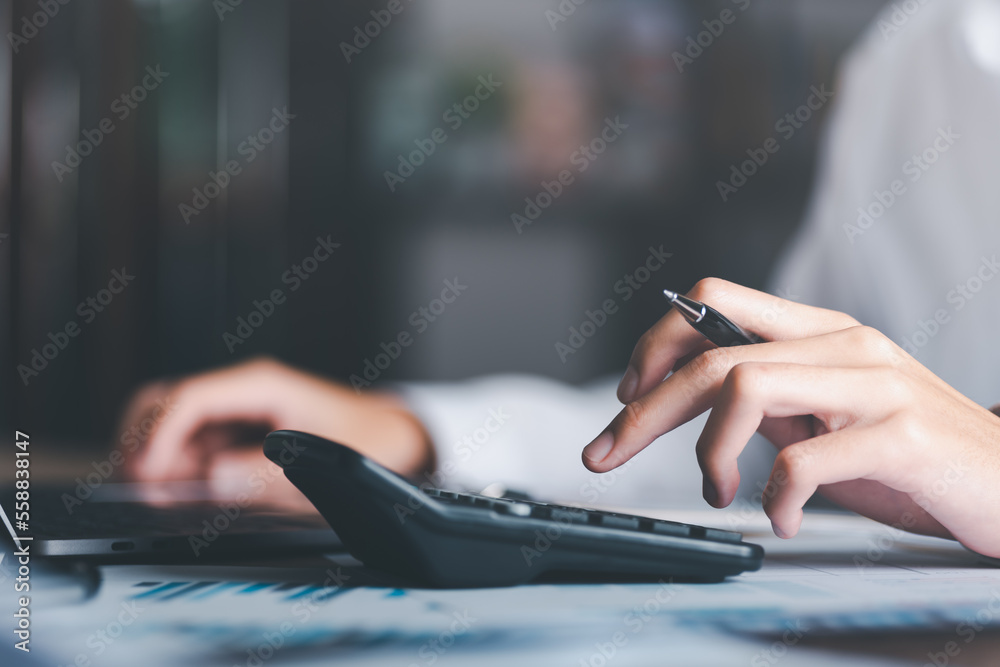 Aufkleber businessman calculating figures in company financial documents with a calculator,analysis of company