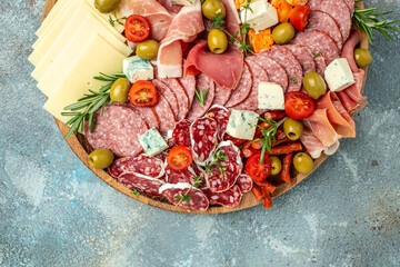 Appetizers table. Cheese, fuits and meat board on a blue background. banner, menu, recipe place for...