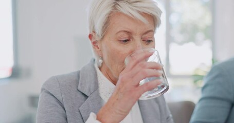 Meeting, office and senior woman drinking water while planning a project with her team in the boardroom. Collaboration, teamwork and elderly manager enjoying a drink while working with her colleagues