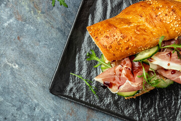 Ciabatta sandwich with jamon ham serrano paleta iberica, arugula, Mediterranean appetizer....