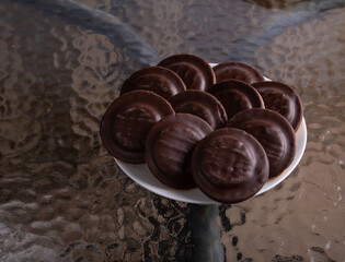photo on the glass table is a plate with cookies in icing