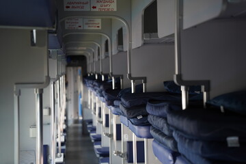 Almaty, Kazakhstan - 05.20.2022 - Passage in a passenger train carriage with seats for passengers.