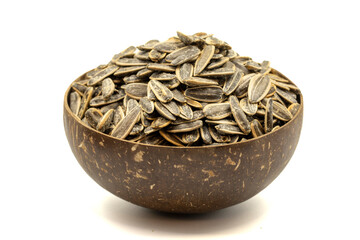 Shelled sunflower seeds isolated on white background. Salted sunflower seeds in a coconut bowl....