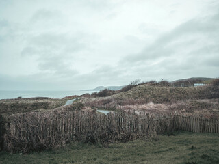 Fototapeta na wymiar Clouds and rain over the ocean along the Welsh coastal path and coastline.
