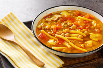 Rancho canario, a typical Canary Islands dish with chickpeas and noodles closeup on the plate on...