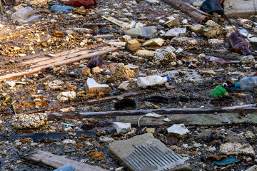 Garbage dump in pond. City dump on the territory of the river. Environmental pollution by household waste. Ecological disaster in undeveloped countries. Garbage in the forest and on the seashore