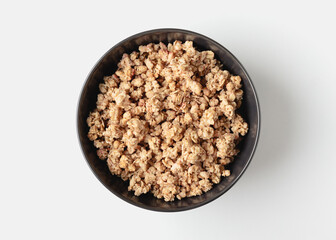 Granola in bowl on light background.