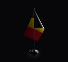 Small national flag of the Belgium on a black background