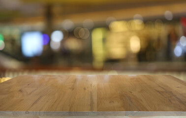 Wood table top in front of abstract blurred background. Empty wooden table space for text marketing promotion. blank wood table surface copy space