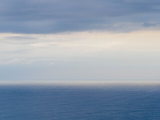 Naklejka na ściany i meble Low evening clouds over Tasman sea coast