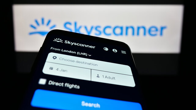 Stuttgart, Germany - 12-30-2022: Mobile phone with website of travel metasearch company Skyscanner Ltd. on screen in front of business logo. Focus on top-left of phone display.