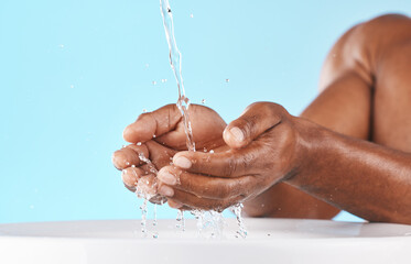 Water splash, hands and cleaning with beauty and black man, hygiene zoom and hydration with water mockup. Clean water drops, splash and skincare with natural cosmetics against blue studio background