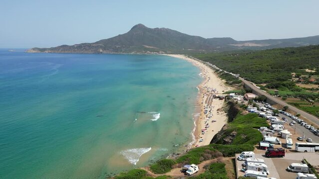 RV Motorhomes camping at Blue Sea and San Nicolo Beach in Buggerru, Sardinia, Italy - 4k Aerial