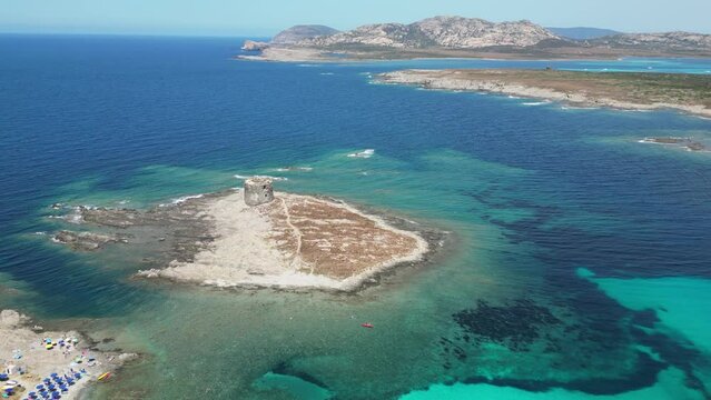 Spiaggia della Pelosetta Beach and La Pelosa island tower in Sardinia, Italy - 4k Aerial