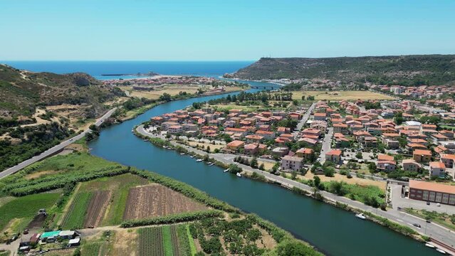 Temo River flows through Bosa into the sea at Sardinia, Italy - 4k Aerial