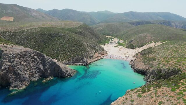 Cala Domestica Beach, Blue Cove and Green Mountains in Sardinia, Italy - 4k Aerial