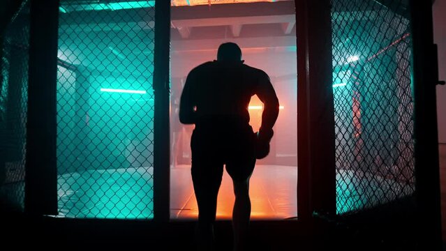 MMA fighters enter the cage ring. Mixed martial arts fight. Cinematic staged fight. Boxing in a ring or cage. Two fighters fight for the right to be the champion.
Boxer in the boxing gym. Bandages his