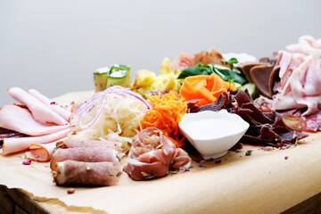 Cold appetizer of fresh vegetables and meat on the buffet table
