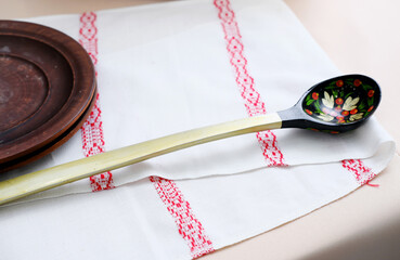 Russian Khokhloma spoon and bowl on a napkin with a Slavic pattern