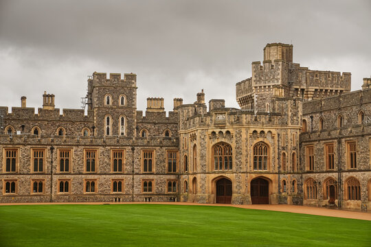 Windsor Castle in England during a cloudy rainy day, view from the interior courtyard. Landmark photo historical building symbol for Uk royal. Windsor, United Kingdom, 2022.