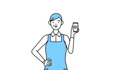 仕事でスマホを使うエプロンを着たシニア女性