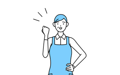 ガッツポーズをするエプロンを着たシニア女性