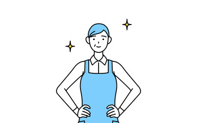 両手を腰に当てたエプロンを着たシニア女性