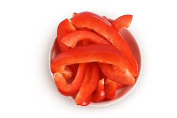 slices of red sweet bell pepper in ceramic bowl isolated on white background with full depth of field. Top view. Flat lay