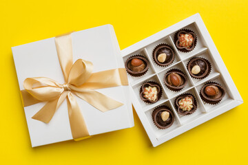 White box with chocolates candies and golden tape. top view with copy space