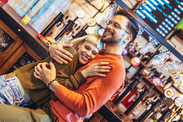 Fototapeta na wymiar Portrait of a beautiful couple while having romantic moments in cafe.