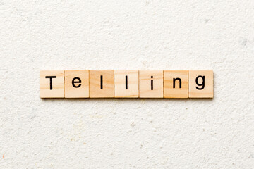 telling word written on wood block. telling text on table, concept