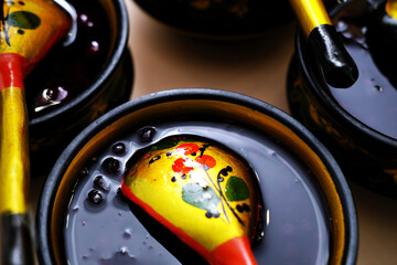 Russian folk Khokhloma dishes with jam. Top view